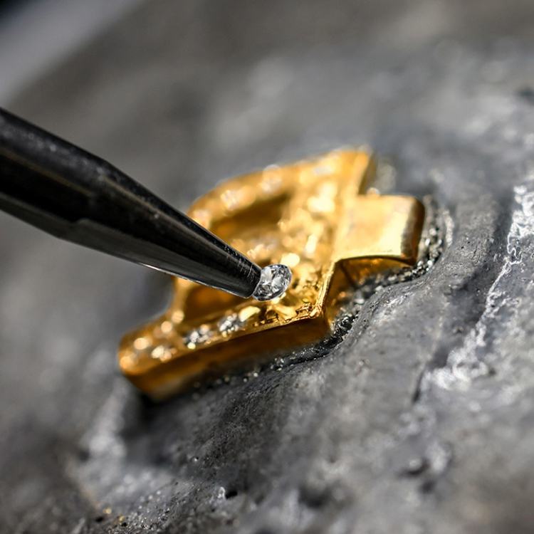 Handcrafting a diamond-set Loveletters bracelet in Pragnell's British workshop.