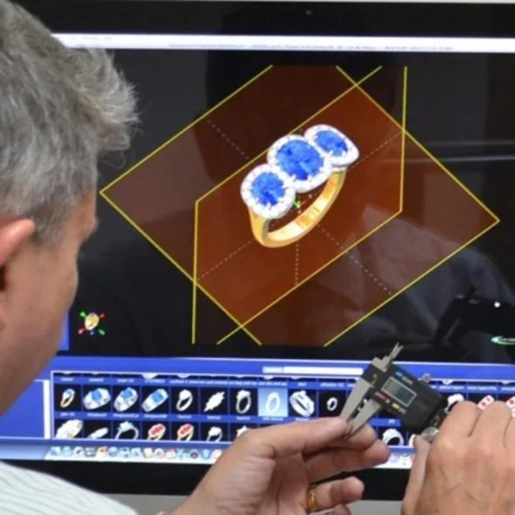 Jeweller reviewing a bespoke ring design using specialist digital technology