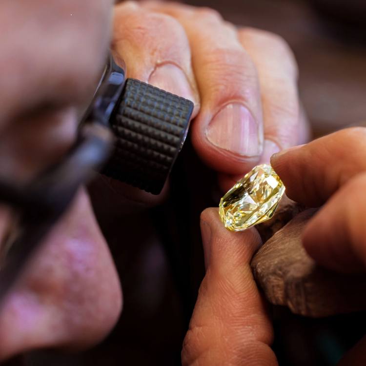 Expert jeweller assessing a diamond using specialist craftsmanship and years of experience
