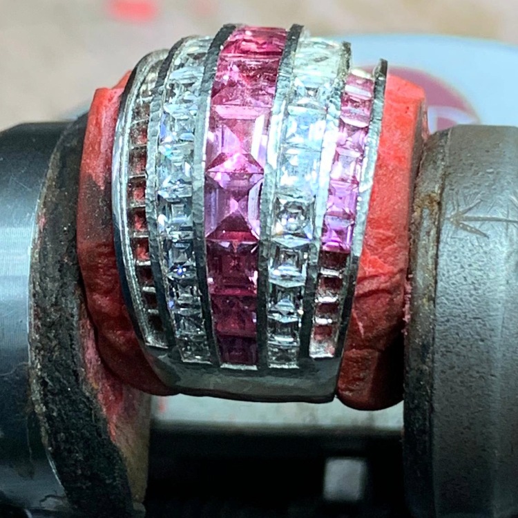 Calibre‑cut diamonds being precisely set in an American partner workshop