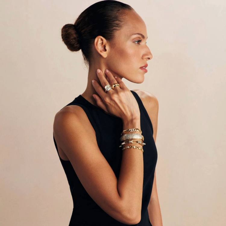 Model wearing stacked diamond tennis bracelets with elegant jewellery styling